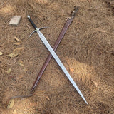 Sword with sheath on dry grass