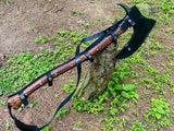 Wooden axe with leather strap on a natural background