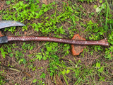 Wooden weapon with a blade on a grassy ground
